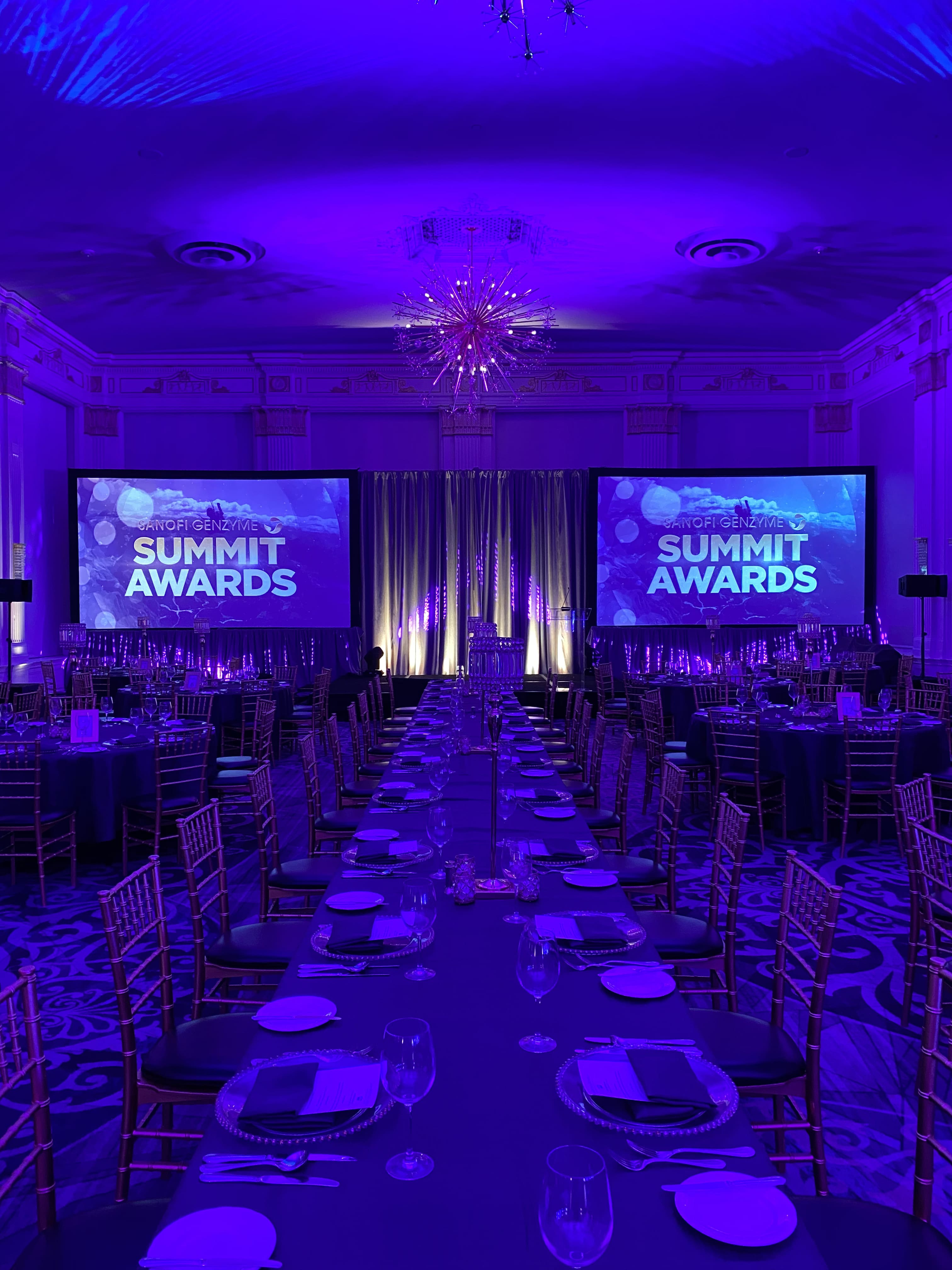 Summit Awards gala with blue uplighting and dual screens