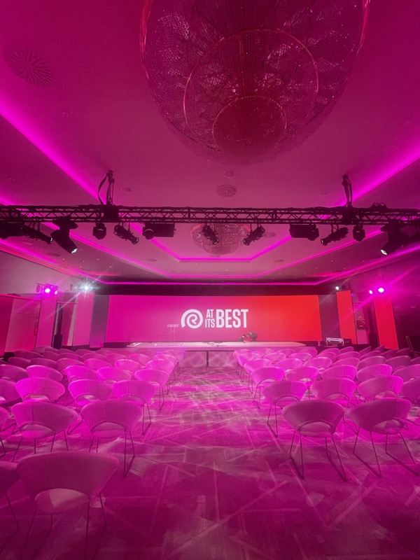 Pink-lit conference stage designed by FPC production team